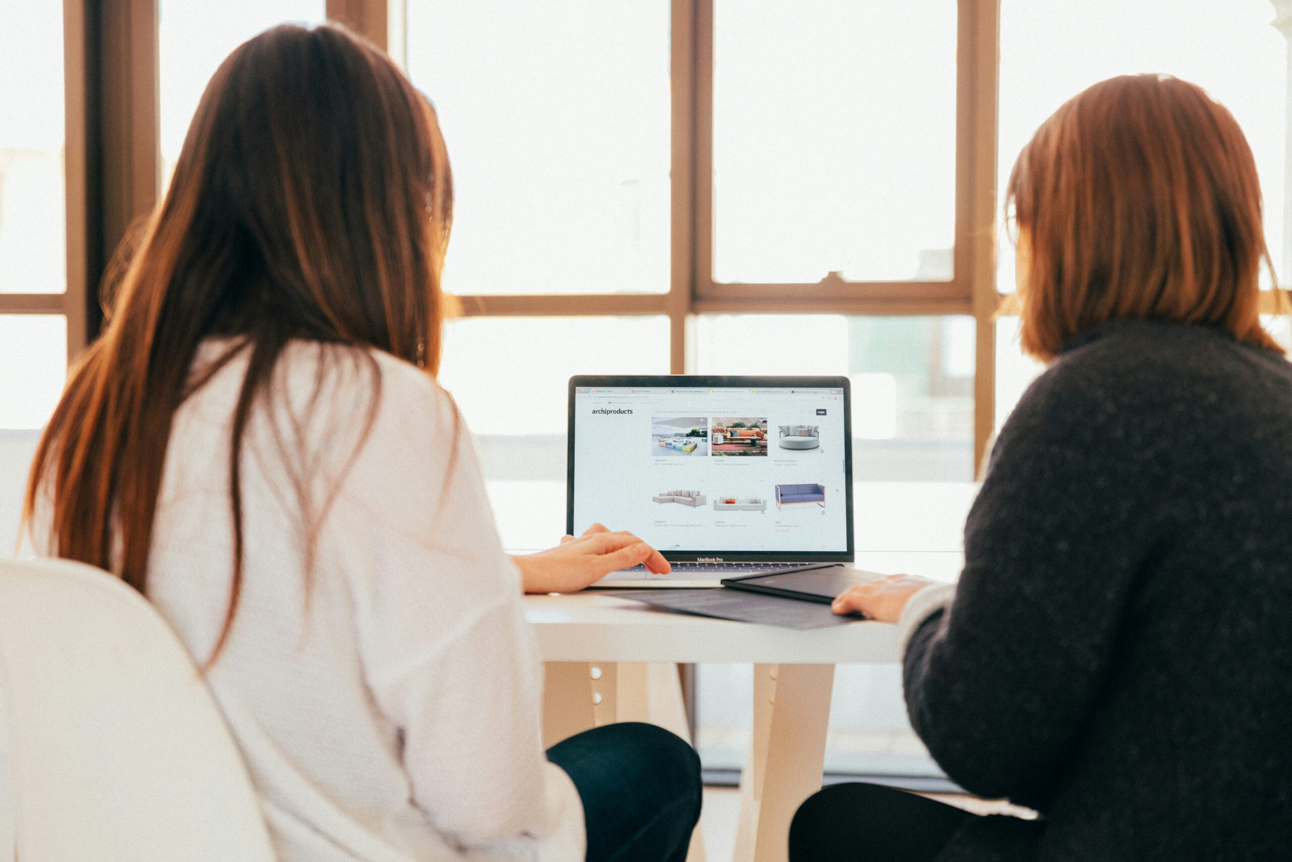 Two professionals reviewing website content and brand messaging during a strategic website planning session focused on customer experience and business growth.